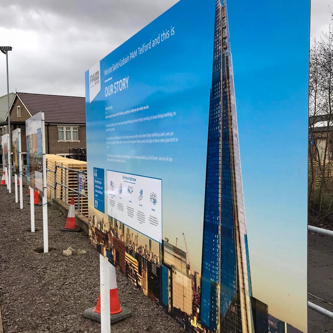 Outdoor printed post and plate sign at a Saint-Gobain building site