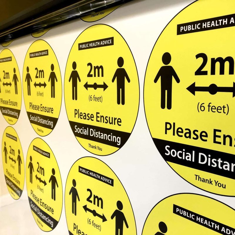 Circular social distancing stickers in the process of being printed