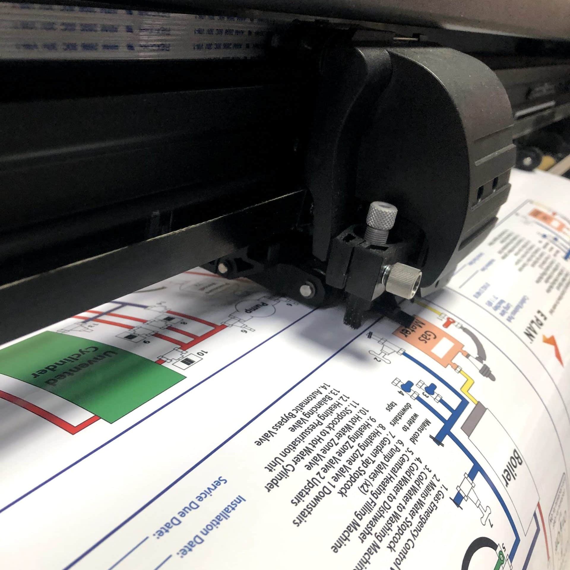 Printed boiler stickers in the process of being plotter cut